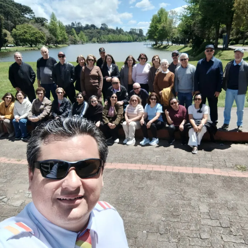 Ivanir fazendo uma selfie com um grupo da Almeida à beira do lago